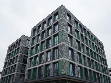 Clean, modern architectural building with integrated green technology, natural overcast daylight, cool slate and deep emerald tones, wide-angle lens, realistic