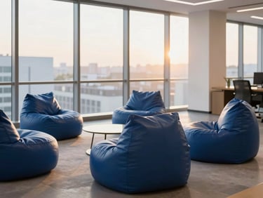 A minimalist corporate office lounge with floor-to-ceiling windows, structured deep blue leatherette bean bags in a collaborative circle, warm afternoon light