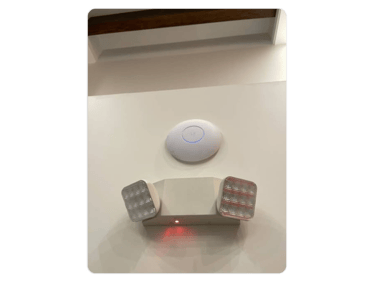 a wall mounted light fixture with a remote control