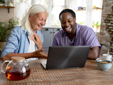 A compassionate male homecare provider offering attentive care and emotional support to an elderly