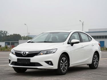 Front three-quarter view of a clean mid-size sedan parked on an outdoor lot in overcast daylight, no people, honest unedited paint and bodywork visible, organized background