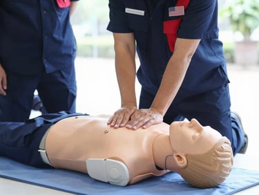 Hands-on CPR training on a mannequin, with a volunteer in uniform observing, natural indoor training light, crisp navy and signal red accents, sharp focus, 35mm lens.