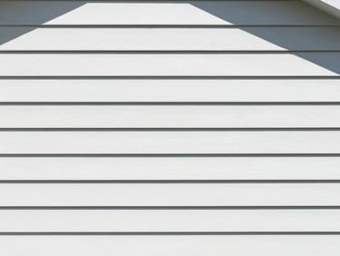 Clean residential house siding, soft-wash, crisp daylight, professional editorial style.