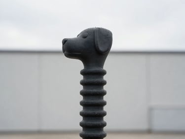 Close-up of a non-toxic rubber dog toy with a clean industrial backdrop, soft overcast daylight, sharp focus