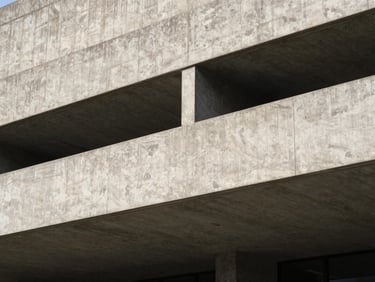 Stark architectural detail of a brutalist concrete structure, heavy geometric lines, high-contrast shadows, clinical composition.