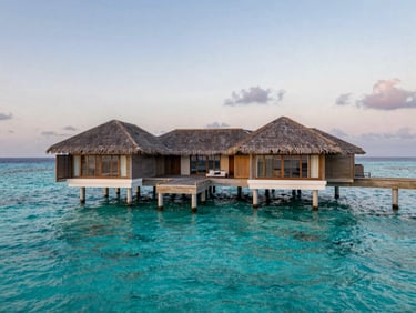 Overwater villa in the Maldives, absolute uninterrupted silence, crystal-clear turquoise water under soft twilight sky.