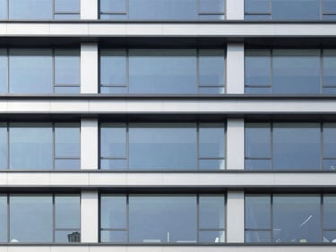 Architectural rendering of a sleek, modern commercial building facade, bright natural daylight, clean lines, professional architectural photography.