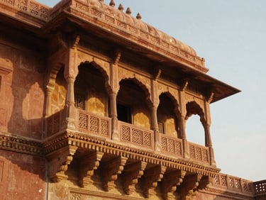 Intricate carved sandstone balcony of a Rajasthani palace, warm golden-hour light, soft shadows, 35mm lens