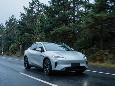 A clean modern car driving on a wet asphalt Oregon road lined with tall green pine trees under soft overcast daylight, cool blue tones, 35mm lens
