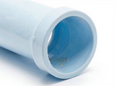 Detailed shot of a clean, internal pipe section free of scale, contrasting with a section showing mineral buildup, crisp product photography, bright high-key studio light, minimalist blue and white tones, 50mm.