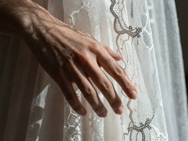Extreme close-up of hands touching, showcasing delicate lace veil fabric texture under sharp directional light, high contrast.