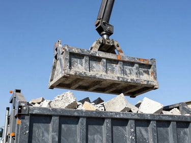 Close-up, low-angle heroic shot of heavy truck hydraulics lifting a roll-off dumpster filled with concrete debris, bright California daylight, sharp focus.