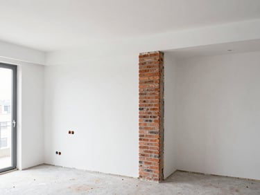 Interior of a modern apartment renovation in progress, clean white walls, exposed structural brick detail, natural light