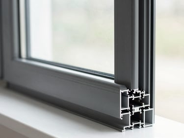 Close-up of a high-performance anthracite aluminum window profile, clean double glazing, natural light
