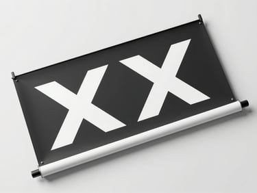 Overhead flat-lay of a printed rollup banner and X-banner leaning against a clean white wall, studio strobe lighting from above emphasizing the sharp graphic surface and material finish, tight crop showing banner top edge and stand hardware