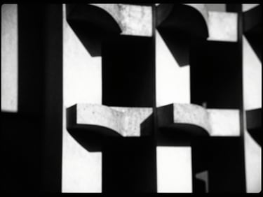 Abstract geometric shapes, high-contrast chiaroscuro lighting, deep shadows, sharp focus, 35mm film