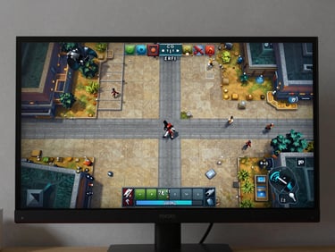 Full-screen gameplay frame — a top-down or side-scrolling game scene with clear tile work and UI elements visible — captured directly from monitor display under ambient room light, no device framing