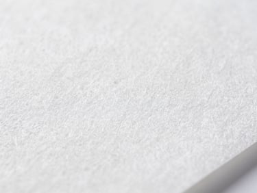 Macro close-up of micro-fiber paper texture, bright clinical studio light, sterile white and cool gray tones, showing fine, dense fibers