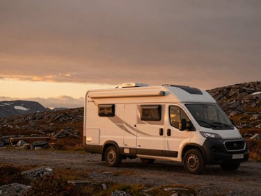 A reliable Weinsberg camper parked in a rugged Nordic landscape, clean design, practical setup under a dramatic twilight sky