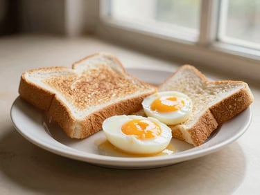 A plate of traditional Malaysian breakfast with soft boiled eggs and toast, warm morning light