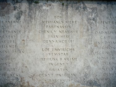 Close-up of engraved names on a weathered stone war memorial, soft overcast daylight, desaturated tricolor tones, deep shadows, 35mm film grain