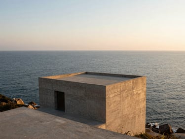 Wide panoramic 21:9 framing of a minimalist concrete structure integrated into a coastal cliff, uninterrupted sea views, generous negative space, warm golden hour.