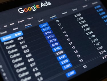 Google Ads performance interface close-up on dark screen, click-through and conversion columns highlighted in neon blue, tight overhead framing, high contrast studio lighting