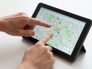 An older adult's hand and a young child's hand together pointing at a large, highly legible interactive map on a physical Android phone screen, bright natural studio lighting.