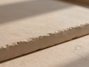 Macro shot of hand-pressed raw clay tile edge, soft Arizona morning light casting gentle shadows, matte earthy texture, warm editorial style.