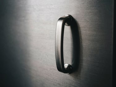 Abstract close-up of a brushed platinum vault handle, soft directional shadows, ultra-clean lines, dark moody editorial photography