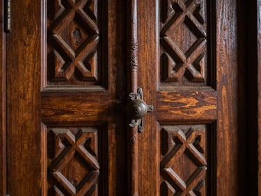 A thick solid timber door deeply carved with geometric Saharanpur motifs, macro detail of the raw wood texture