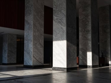 Premium architectural photography of a luxury hotel lobby interior with marble pillars, dramatic shadows, crisp morning daylight, minimalist design, Hasselblad medium format.