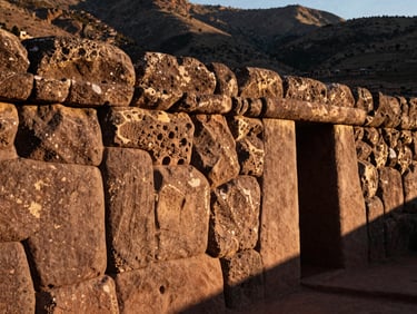 Close-up of ancient Inca stone foundation in San Blas, Cusco, warm sunlight highlighting the texture of the hand-carved stone.