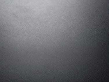 Close-up of fine-grain leather, dark, high contrast, soft diffused daylight, sharp focus.