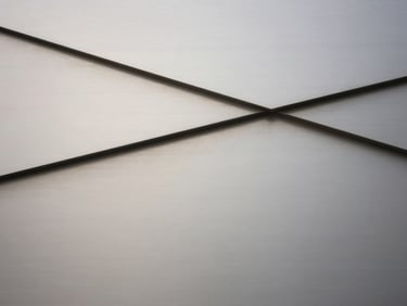 Brushed steel texture, abstract, architectural lines, soft diffused daylight, high contrast.