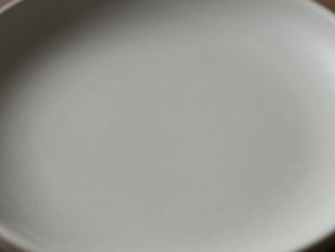 Macro shot of a matte ceramic surface, minimalist, soft diffused daylight, high contrast.