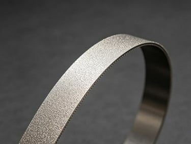 Electroplated diamond wheel performing precision contour grinding on carbide workpiece