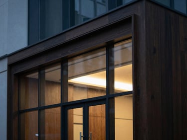 Architectural detail of a modern law office interior, clean geometric glass and dark wood, dramatic high-contrast lighting.