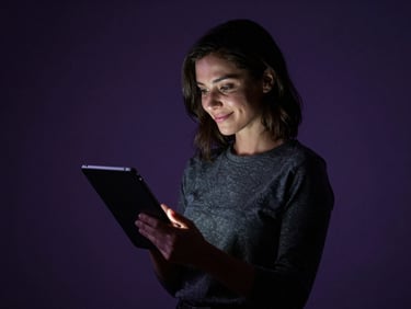 Confident woman in a tasteful studio environment, looking at a tablet with a subtle smile, high-contrast chiaroscuro lighting.