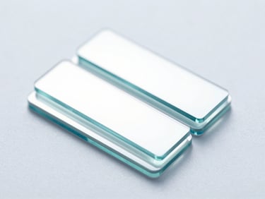 Macro close-up of pristine microscope cover slips catching bright clinical light, showing flawless glass edges stacked in a cleanroom environment, high-key studio lighting, blue and white tones.