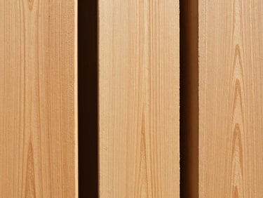 Large, evenly cut wooden planks and pillars, close-up, showing rich grain texture, natural bright daylight, sharp focus, clean architectural framing, 35mm