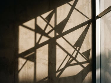 Abstract geometric shadows cast on a warm minimalist concrete wall, sharp lines, architectural detail, high-contrast film style.