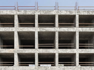 Industrial architectural photography of a concrete building under construction, sharp structural details.