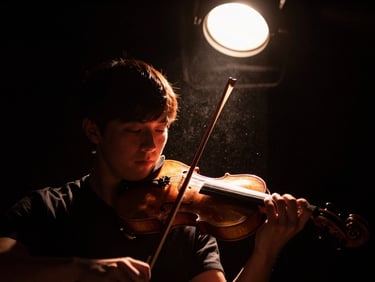 High-contrast cinematic close-up of a violinist performing under a single warm copper spotlight, dust particles visible in the air, deep black background