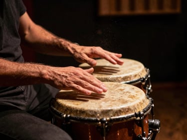 Hands playing a traditional Argentine bombo leguero drum in a dark recording studio, warm copper spotlighting, dust particles in the air.
