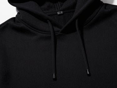 Close-up of heavy-duty double-knit black cotton seam stitching on a premium hoodie, dramatic studio lighting, 35mm film