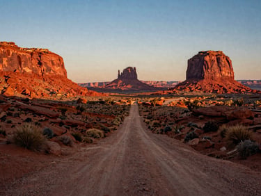 Cinematic shot of a dusty trail winding through red rock mesas in Monument Valley, warm sunset light, vintage road-trip vibe.