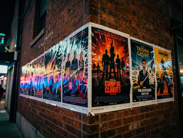 Dynamic low-angle shot of street team flyposting movie posters on a brick wall in an urban alley, blurred city lights bleeding off to the edge, high-contrast, neon glow, 35mm film grain.