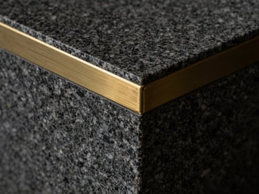Extreme close-up of a heavy dark granite block with a single brushed brass inlay line, dramatic side lighting, deep shadows