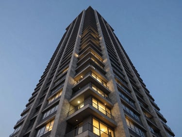 Low-angle architectural photography of a modern luxury residential skyscraper in Noida during the blue hour, sharp geometric concrete lines, glowing windows, clear night sky.